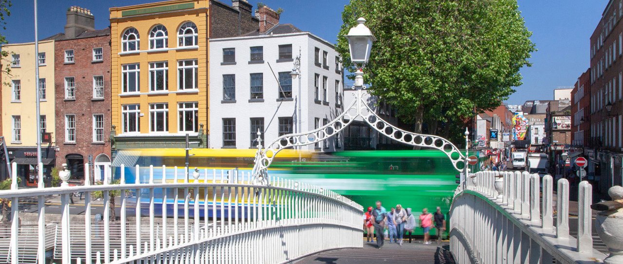 Public and city tour bus passing ha'penny bridge